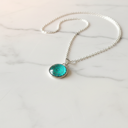 Turquoise mandala petite pendant necklace angled view on marble surface