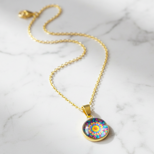 Kaleidoscope mandala petite pendant necklace on white marble surface