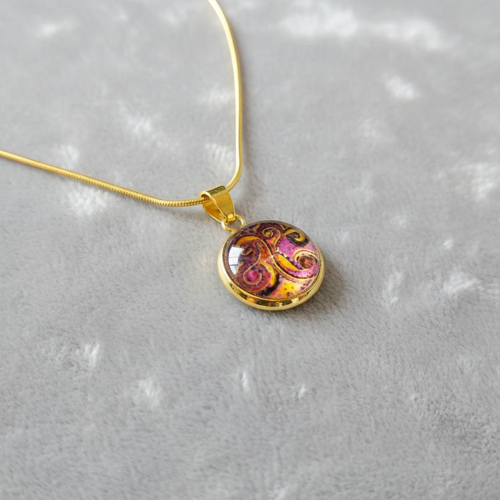 Angled view of petite abstract swirl art pendant on velvet background