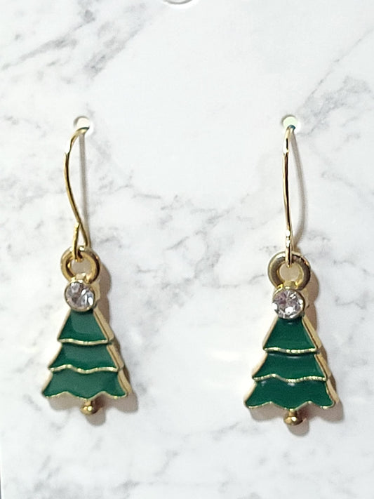 Green enamel Christmas tree dangle earrings with tiered layers, crystal rhinestone accent and gold tone outline on gold French wire on marble surface