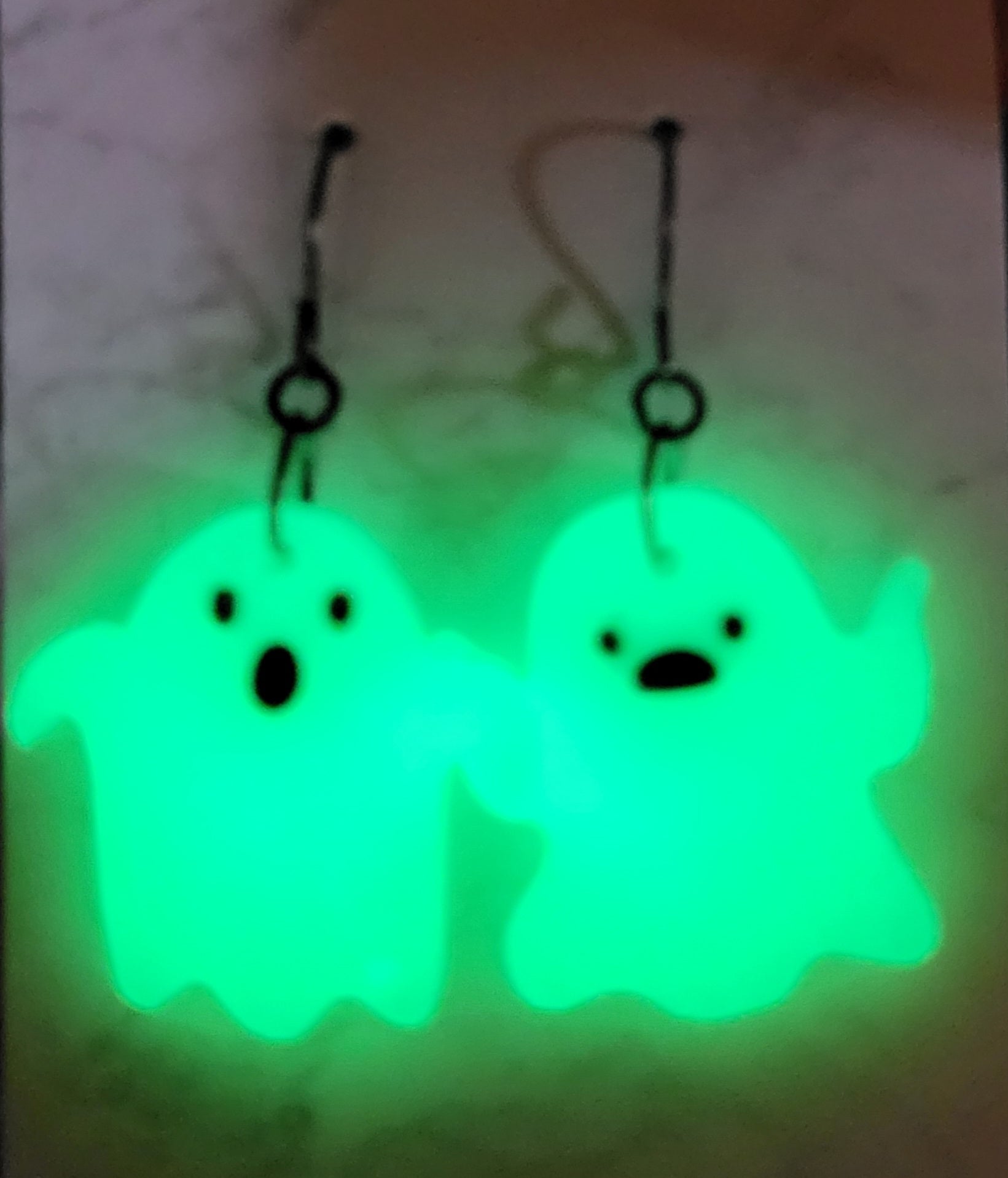 Mismatched ghost glow in the dark resin earrings glowing vivid neon green in the dark