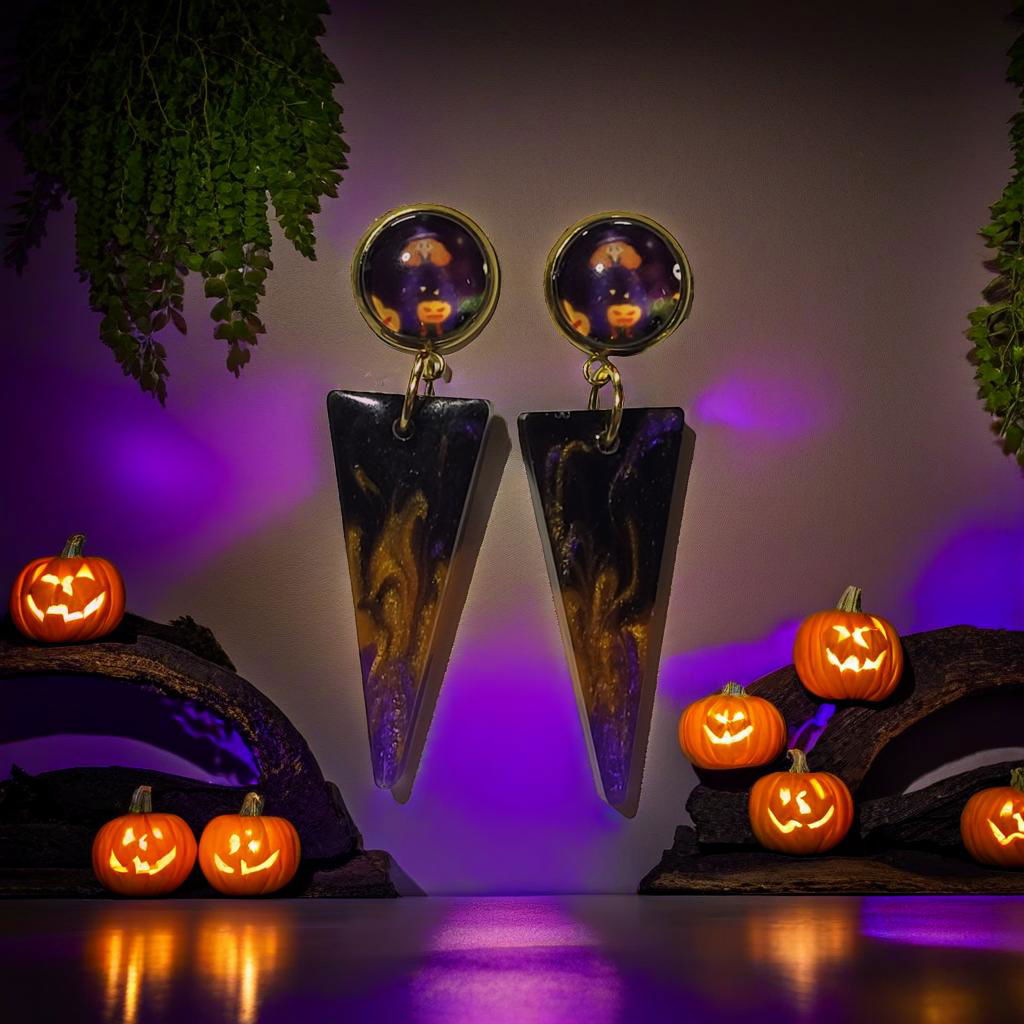 Halloween pumpkin cab resin spike drop earrings styled with glowing jack-o-lanterns and purple Halloween lighting