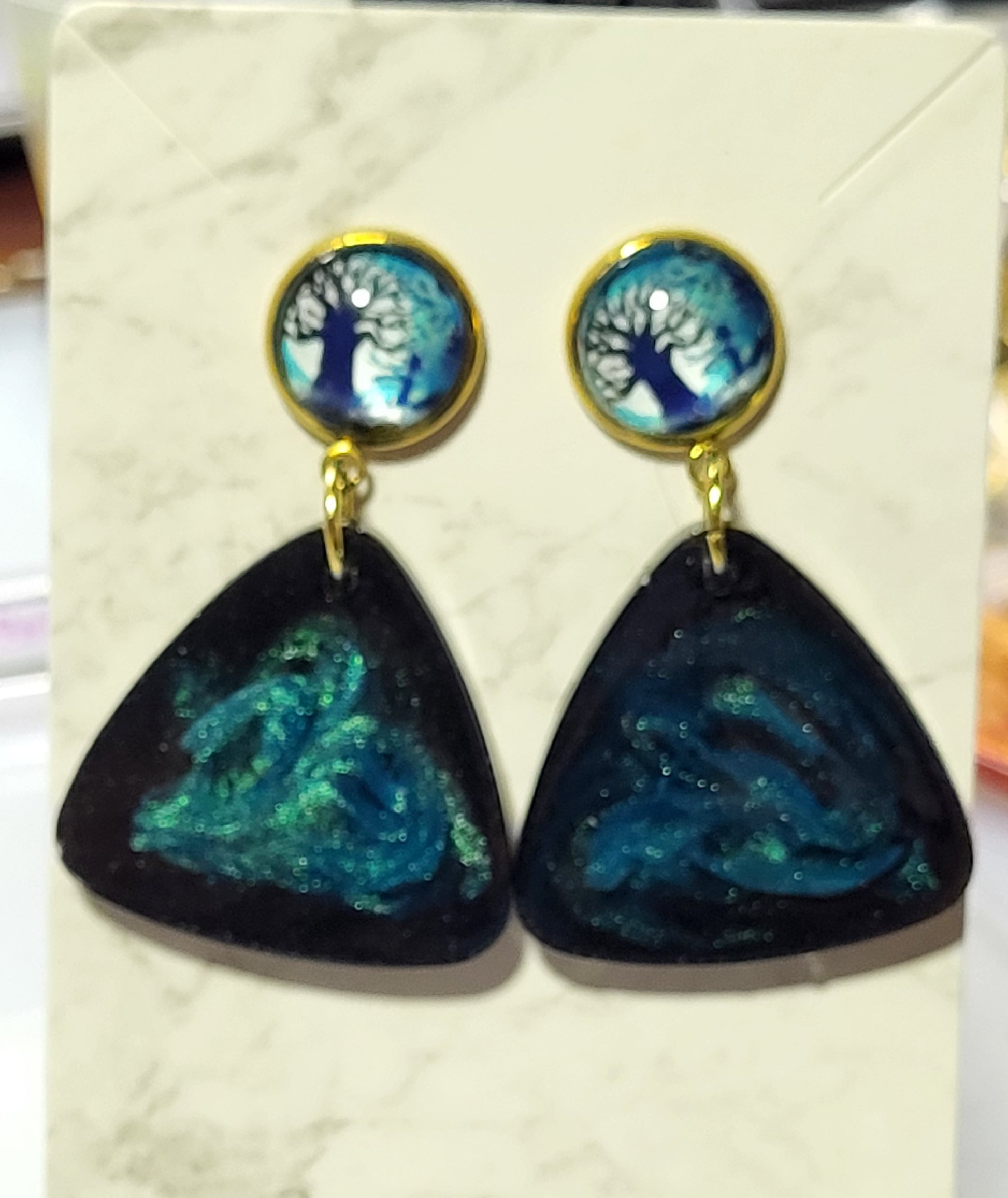 Tree of life glass dome cab stud top with black teal galaxy swirl rounded triangle resin pendant on marble earring card