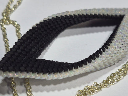 Close-up of black and white woven beadwork around the pendant's open center.