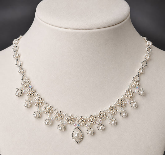 Pearl and crystal beadwoven lace fringe necklace on ivory mannequin bust