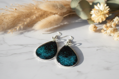 Black and teal glitter earrings with natural stone and botanicals
