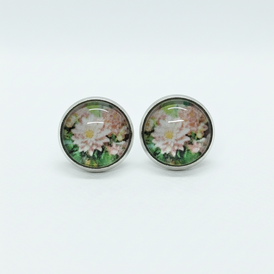 Pink floral stud earrings on white background