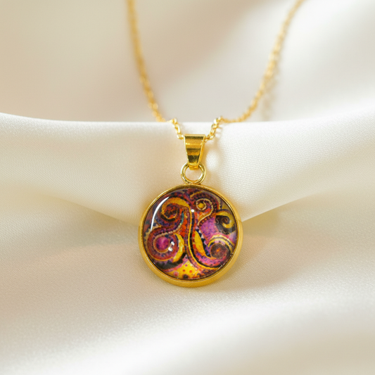 Close-up of glass dome cabochon abstract swirl art pendant on satin