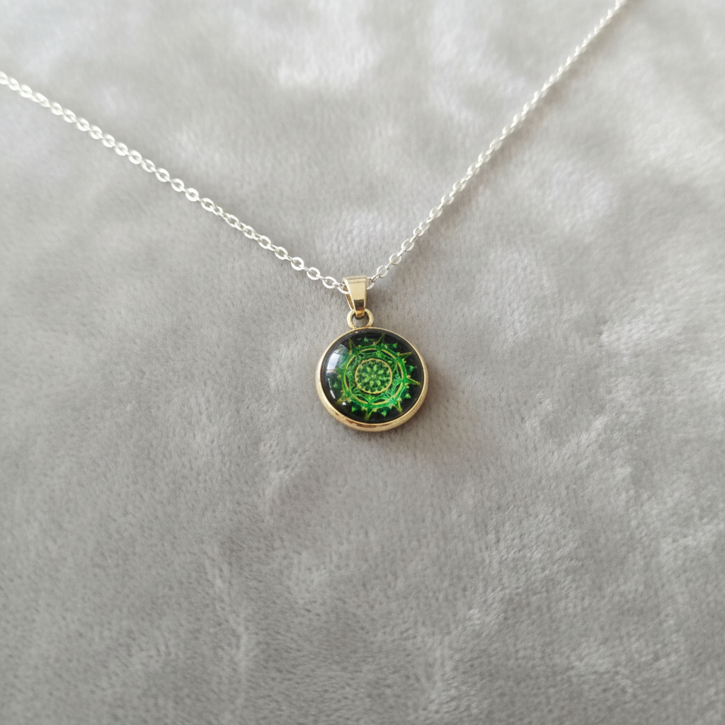 Angled view of petite green spiral mandala pendant on velvet background