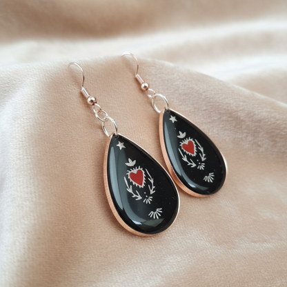 Sacred Heart Resin Earrings - angled view on velvet