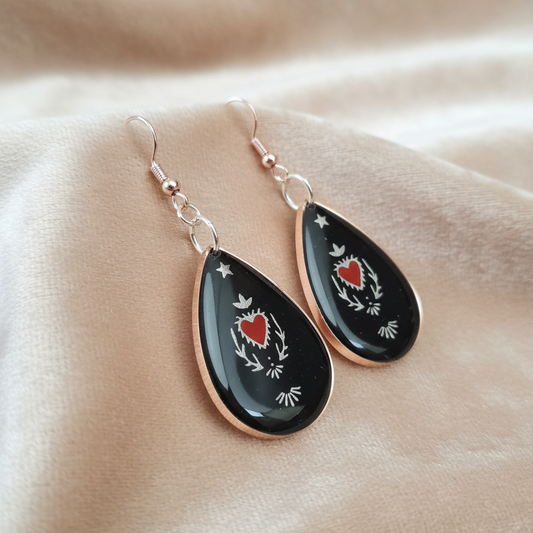Sacred Heart Resin Earrings - angled view on velvet