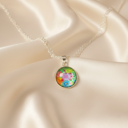 Close-up of glass dome cabochon vibrant floral garden pendant on satin