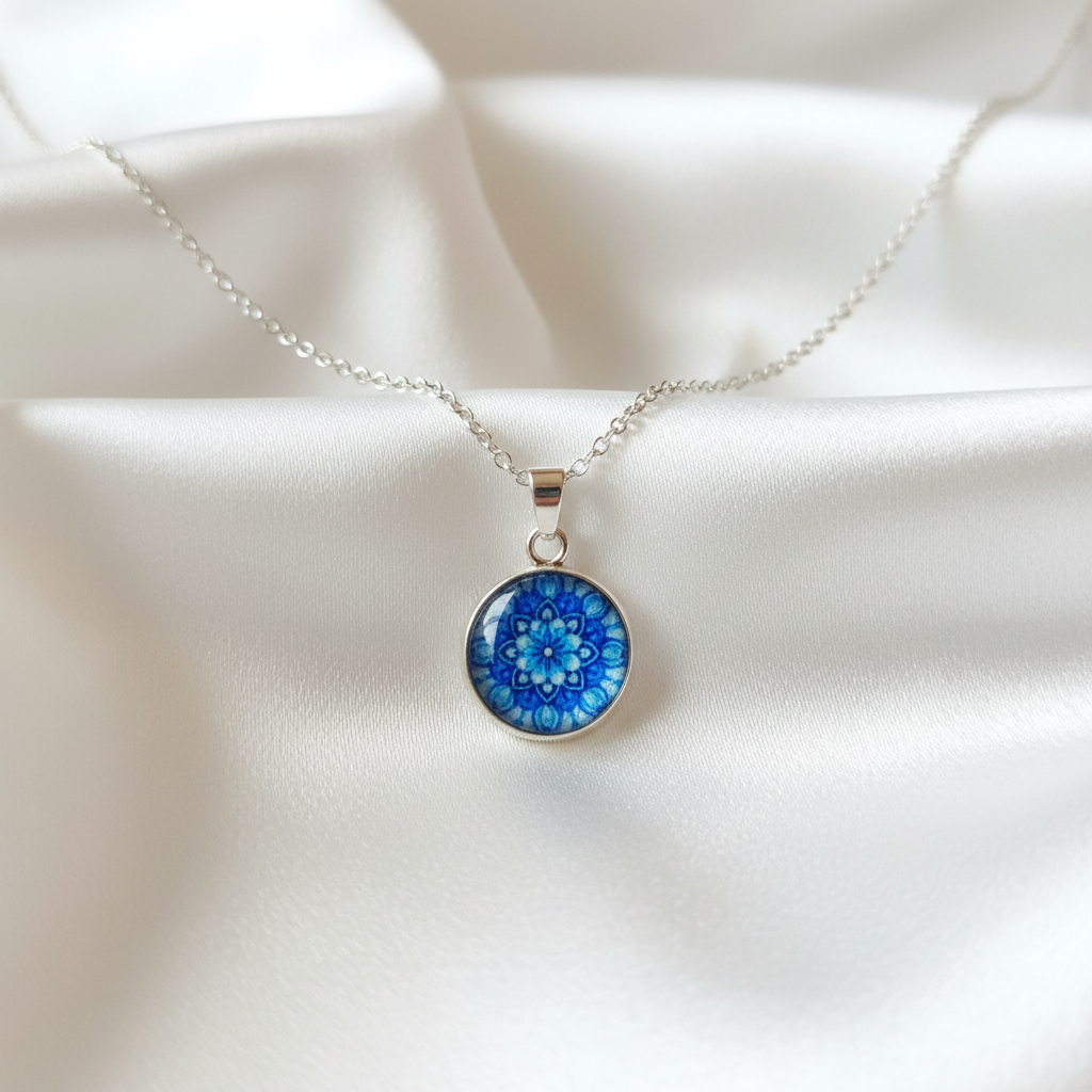 Blue flower mandala petite pendant necklace hero shot on white satin