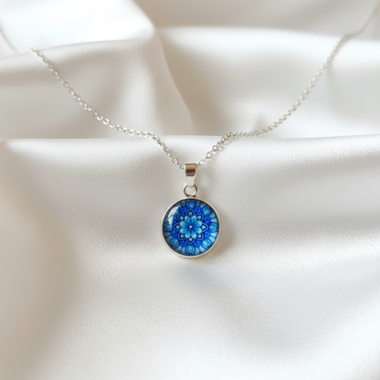 Blue flower mandala petite pendant necklace hero shot on white satin