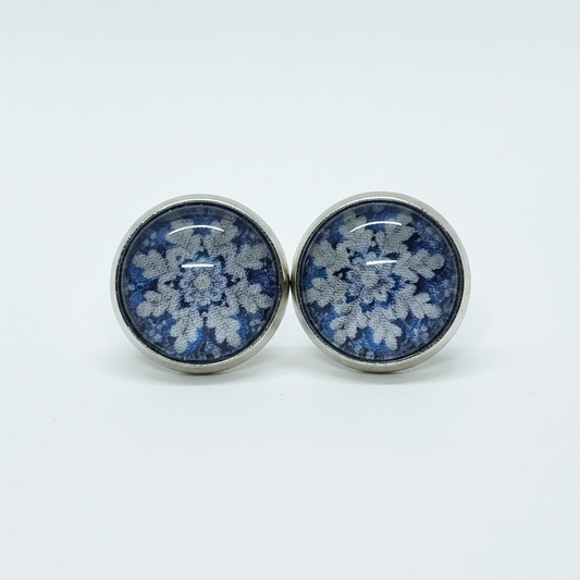Blue floral lace stud earrings on white background