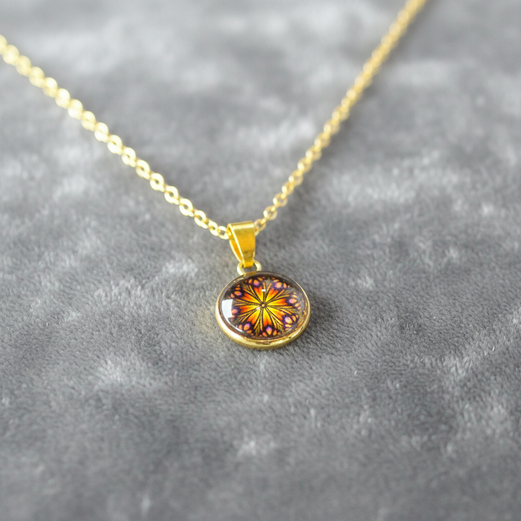 Angled view of petite butterfly mandala pendant on velvet background
