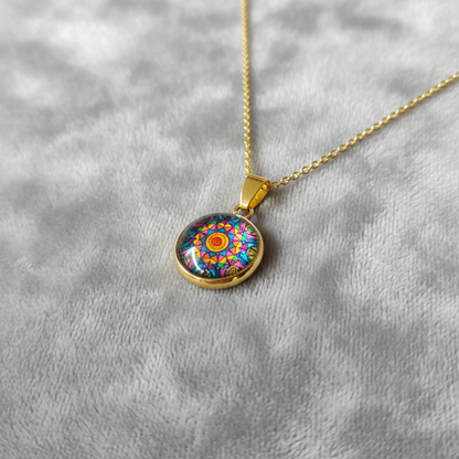Angled view of petite kaleidoscope mandala pendant on velvet background