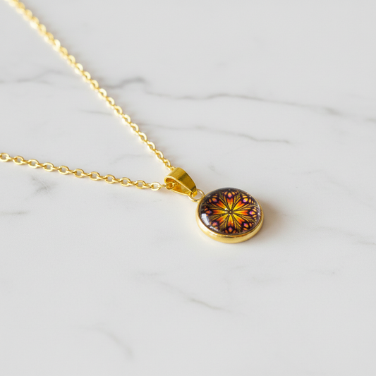 Butterfly mandala petite pendant necklace angled view on marble surface