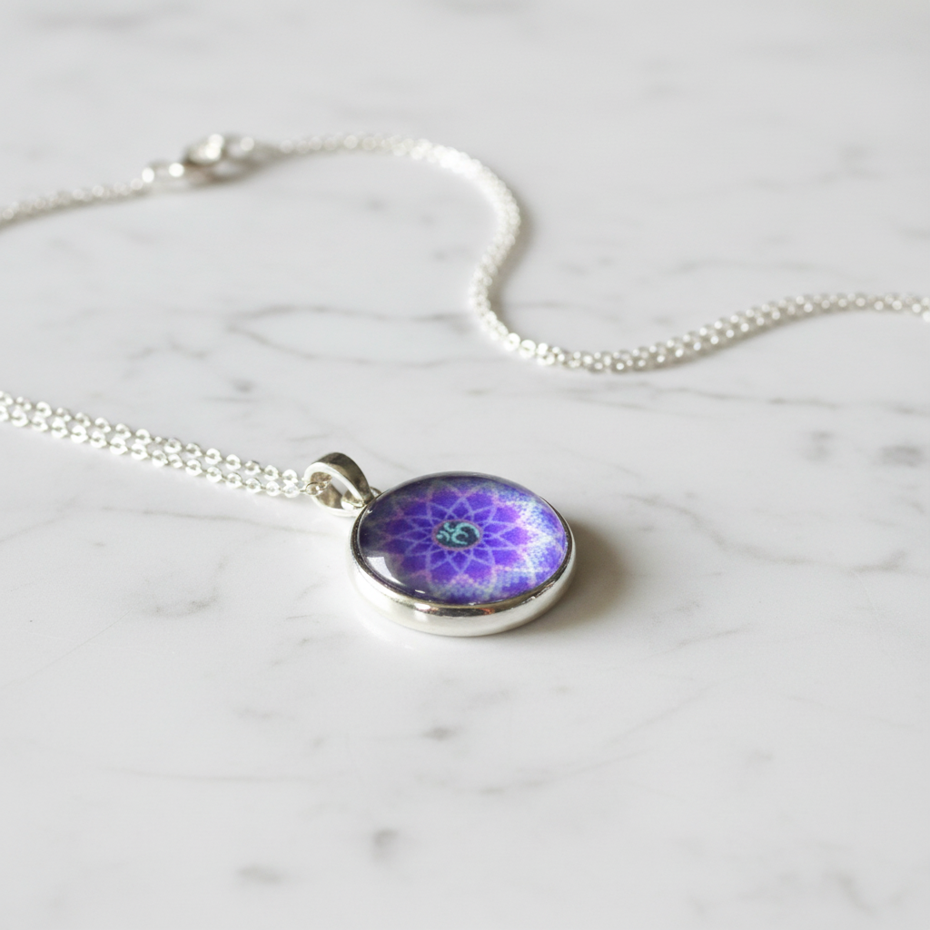 Purple Om mandala petite pendant necklace angled view on marble surface