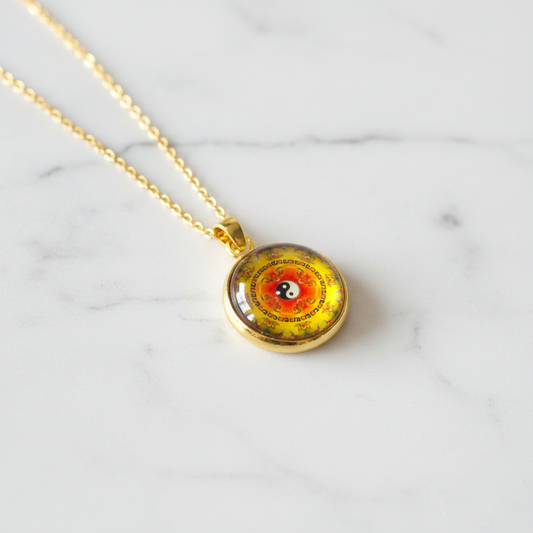 Yin Yang mandala petite pendant necklace on white marble surface