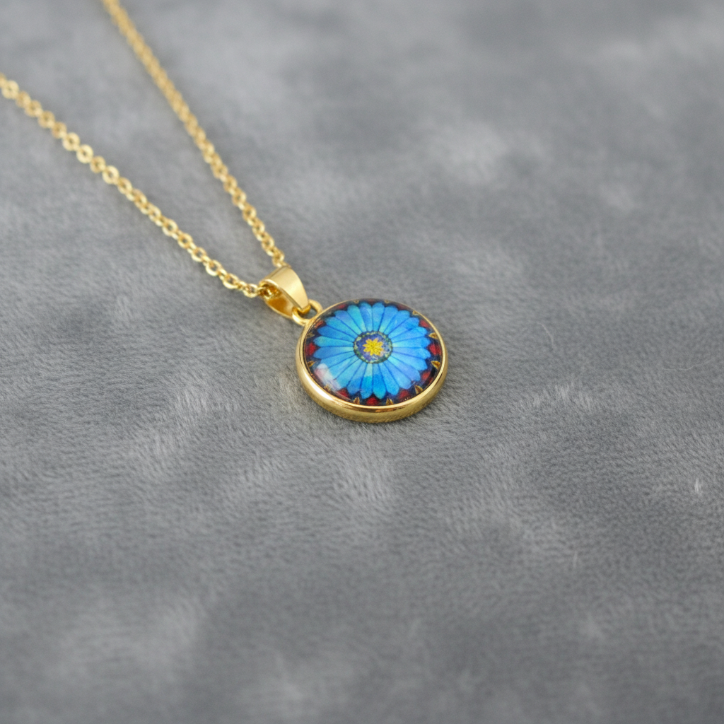 Angled view of petite blue daisy flower pendant on velvet background