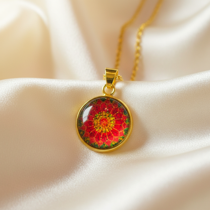 Close-up of glass dome cabochon red zinnia flower pendant on satin