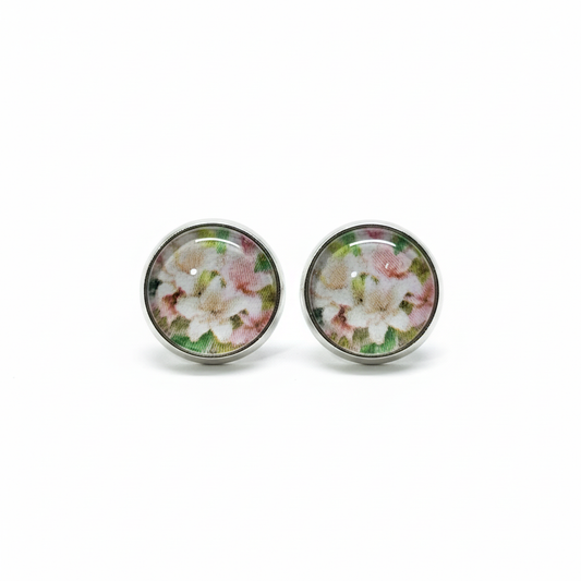 Pink and white floral stud earrings on white background